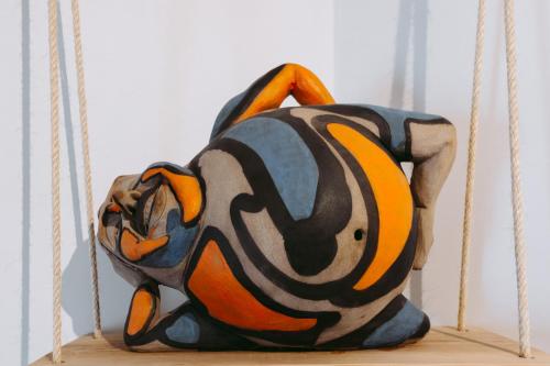 a bag sitting on top of a wooden shelf at 19 Tile Ceramic Concept - by Unlock Hotels in Caldas da Rainha