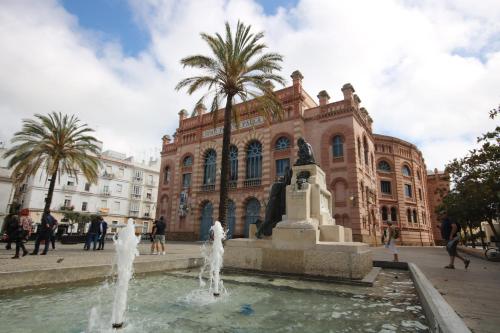 a building with a fountain in front of a building at Oceanum Visum Spa Deluxe in El Trocadero