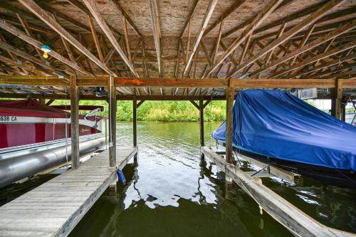 a boat tied to a dock with a blue tarp at Oak Alley in Mineral