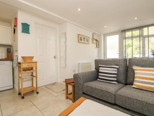 a living room with a couch and a table at Seascape in Porthcurno