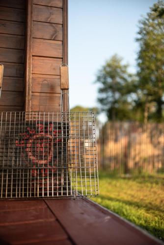 a wire cage on the side of a house at Cottages in Kaprovani "Family nest" in Ureki