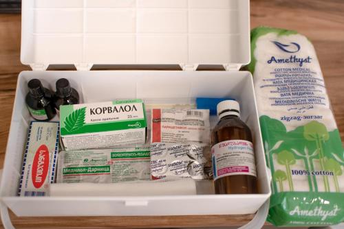 a refrigerator drawer filled with food and medicines at Cottages in Kaprovani "Family nest" in Ureki