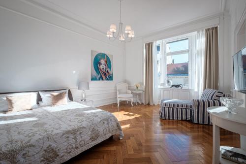 a white bedroom with a bed and a living room at Boutique Charme Apartment Ricarda in Baden-Baden
