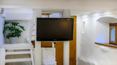 a flat screen tv on a stand in a room at On the Rock Apartments in Šibenik