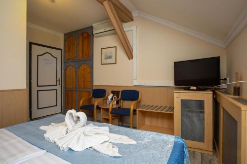 a hotel room with a bed with towels on it at Illés Hotel in Szeged