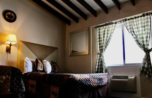 a bedroom with a bed and a large window at Motel Montreal in Lake George