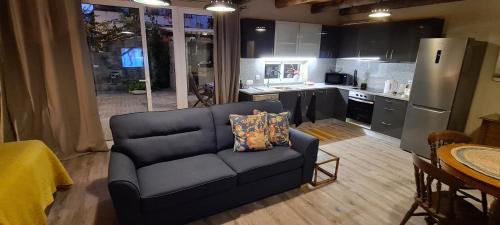 a living room with a couch and a kitchen at Catavento in Porto Santo
