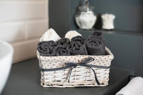 a basket of towels sitting on a table at Beach apartment in the center in Sanremo