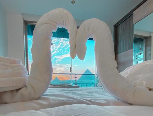 a bed with two swans made out of towels at Best View Pyramids Hotel in Cairo