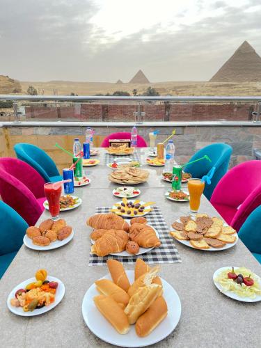 a long table with plates of food on top of a pyramid at Best View Pyramids Hotel in Cairo