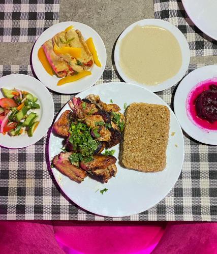 a table with plates of food on a table at Best View Pyramids Hotel in Cairo