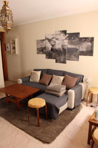 a living room with a blue couch and a table at Casa las Botellas in Grazalema