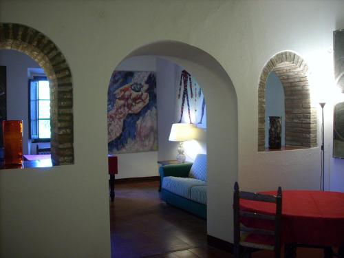 a living room with two arches and a couch at La Scheggia Holiday in Anghiari