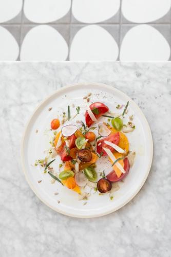 a white plate with vegetables on a counter at Kimpton Everly Hotel Hollywood by IHG in Los Angeles