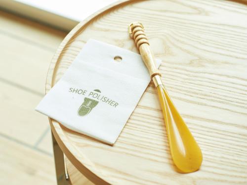 a wooden table with a napkin and a wooden pen on it at Sotetsu Fresa Inn Hiroshima in Hiroshima