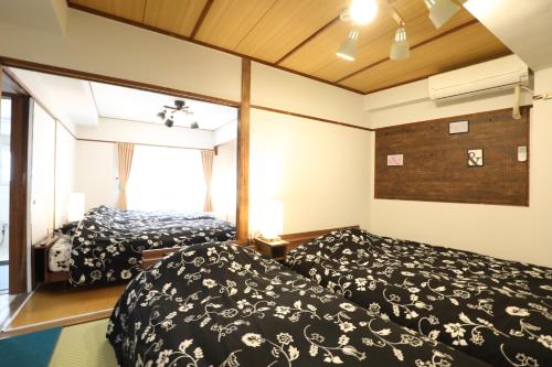 a bedroom with two beds and a window at Fukuoka Condominium in Fukuoka