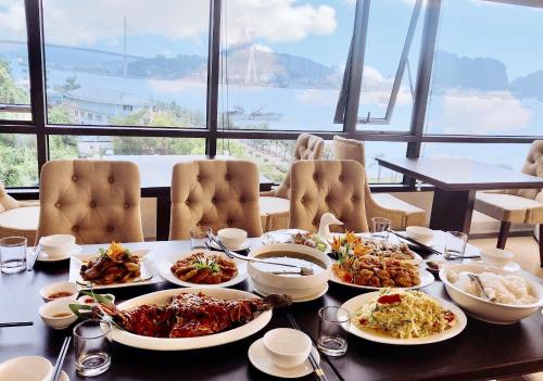 a table with many plates of food on it at Vincent Halong Hotel in Ha Long