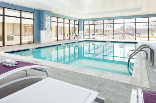 a swimming pool with blue water in a building at Holiday Inn Washington-College Pk I-95 in College Park