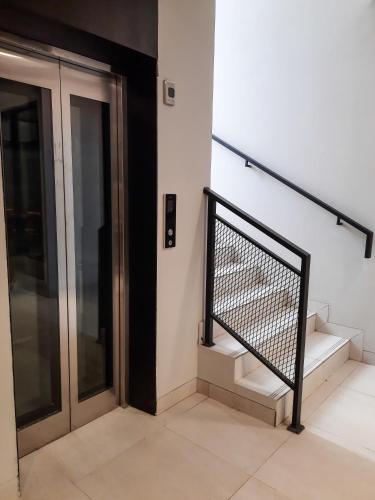 a staircase in a building with a metal railing at Votel Krakatau Boutique Hotel Semarang in Semarang