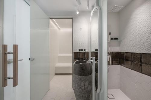 a bathroom with a walk in shower and a toilet at Lagon Life Spirit Boutique Hotel - Adults Only in Chania Town
