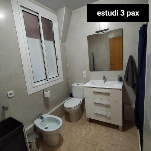 a bathroom with a sink and a toilet and a mirror at Apartament Berga in Berga