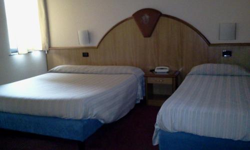 a hotel room with two beds and a window at Hotel motel residence Gonzaga in Cantello