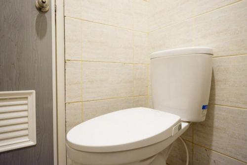 a bathroom with a white toilet in a room at RedDoorz Plus near Jogja City Mall 5 in Yogyakarta