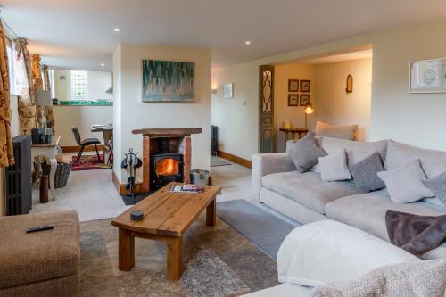 a living room with a couch and a fireplace at Old Chapel in Cheltenham