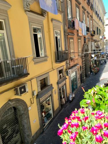 a building with flowers on the side of a street at Toledo Boutique Rooms in Naples
