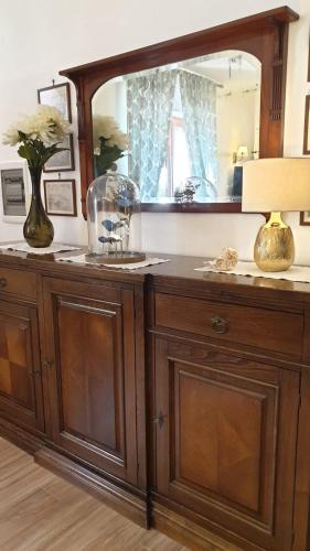 a wooden dresser with a mirror on top of it at Donna Caterì in Termini