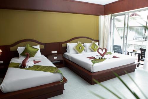 Ένα ή περισσότερα κρεβάτια σε δωμάτιο στο Samui First House Hotel
