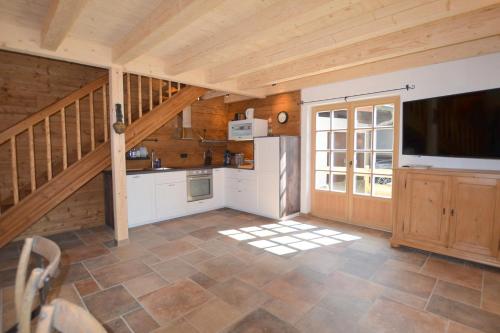 a kitchen with a large screen tv in a cabin at Chalet Kaisereck in Reit im Winkl