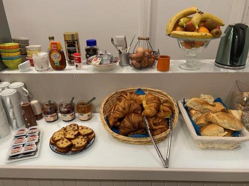 a bunch of bread and other foods on a counter at Hôtel La Villa Lorraine in Toul