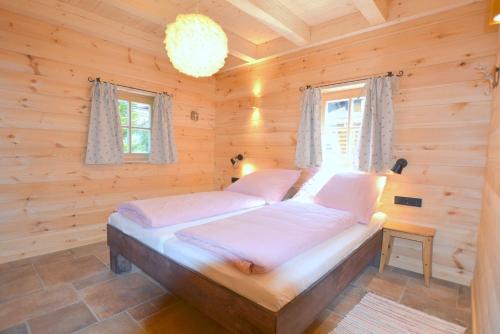 a bedroom with a bed in a log cabin at Chalet Kaisereck in Reit im Winkl