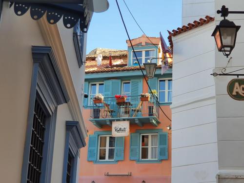 a building with blue windows and a balcony at Kallisti Luxury rooms in Nafplio