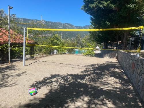 a volleyball net with a ball on the ground at Villa Maroudia in Kymi