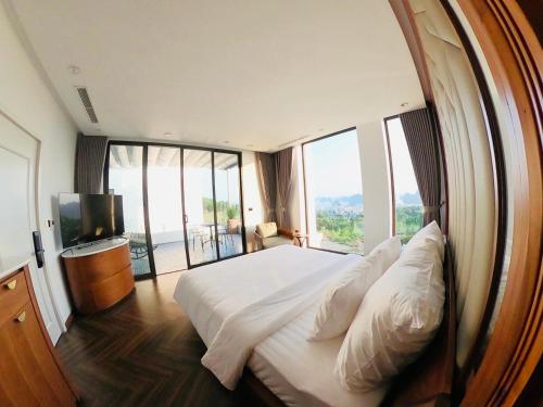 a bedroom with a large bed with a large window at FLC Villa Hạ Long 5 Phòng Ngủ in Ha Long