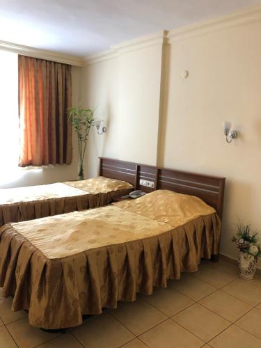 two beds sitting in a room with at BEST HOUSE APART HOTEL-2 in Alanya