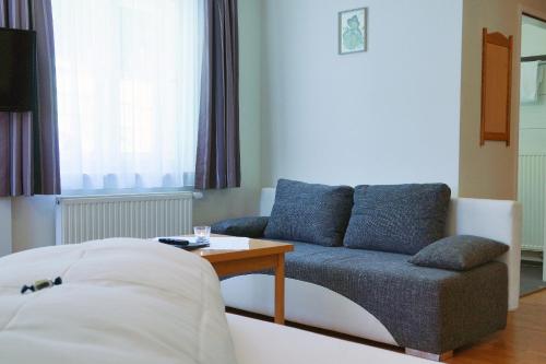 a living room with a couch and a table at Panoramagasthof DaxLueg in Salzburg