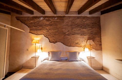 a bedroom with a large bed with two lamps at Castillo De Pilas Bonas in Manzanares