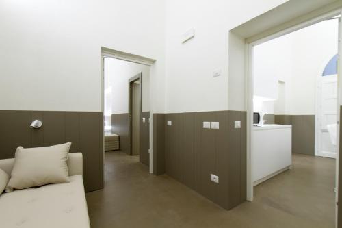 a living room with a bed and a bathroom at Palazzo dei Ciompi Suites in Florence