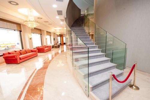 a staircase in a lobby with a red ribbon at Hotel Bahía in Santander
