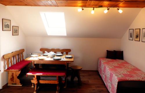 a dining room with a table and a bed at Penzion Bor in Náchod