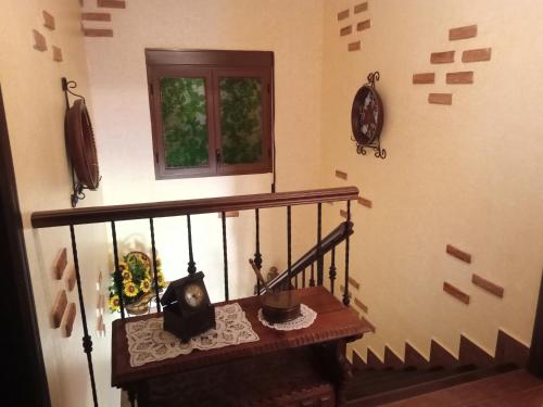 a room with a staircase with a window and a table at sol de membrillo in Santo Tomé