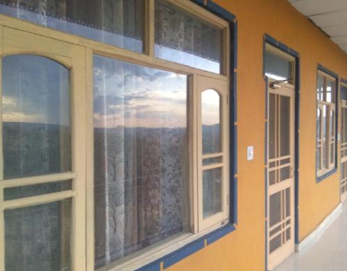 a room with a window with a view at Yellowoaks Guest House in Baijnāth
