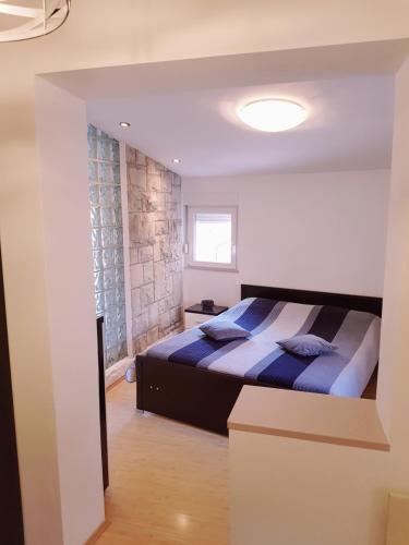 a bedroom with a king sized bed in a room at Apartment Centar Omis in Omiš