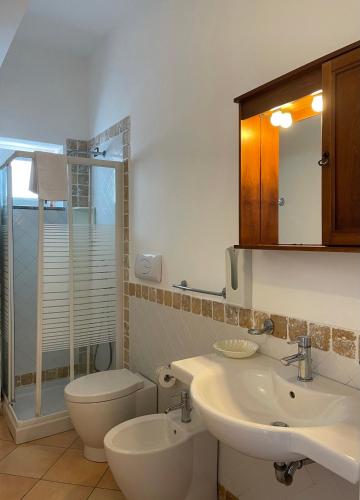 a bathroom with two sinks and a toilet and a shower at Suite De Pasquale Lipari in Lipari