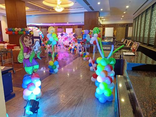 a bunch of balloons are lined up on a dance floor at Comfort Inn Tulip Heights in Bathinda