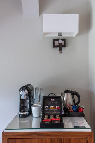 a counter top with a coffee maker and a blender at Natura Mazur Resort & Conference in Warchały