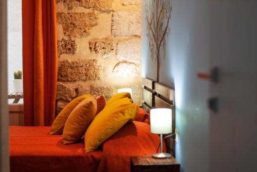 a bedroom with a bed with yellow pillows at Affittacamere B&B Carella in Palermo